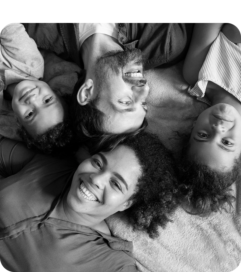 Friends lying with their heads together, smiling